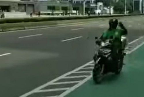 Kocak! Sambil Bawa Paket, Ojol Ini Lintasi Rute Parade Pembalap MotoGP di Jakarta, Polisi dan Masyarakat Sampai Melongo